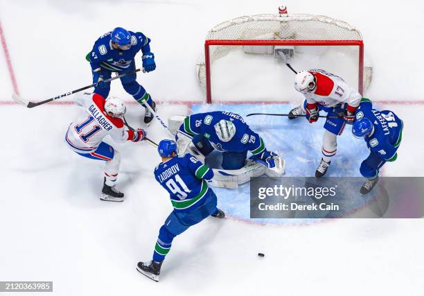 Noah Juulsen Nikita Zadorov Casey DeSmith and Sam Lafferty of the Vancouver Canucks defend against Brendan Gallagher and Josh Anderson of the...