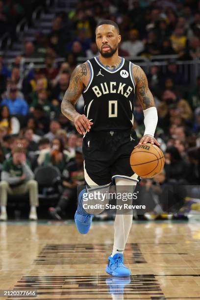 Damian Lillard of the Milwaukee Bucks handles the ball during a game against the Los Angeles Lakers at Fiserv Forum on March 26, 2024 in Milwaukee,...