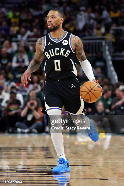 Damian Lillard of the Milwaukee Bucks handles the ball during a game against the Los Angeles Lakers at Fiserv Forum on March 26, 2024 in Milwaukee,...