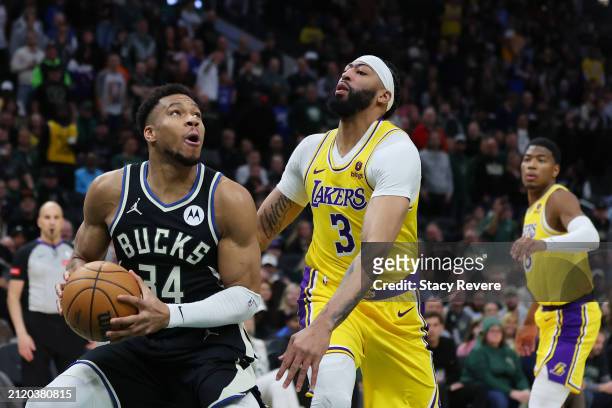 Giannis Antetokounmpo of the Milwaukee Bucks is defended by Anthony Davis of the Los Angeles Lakers during a game at Fiserv Forum on March 26, 2024...