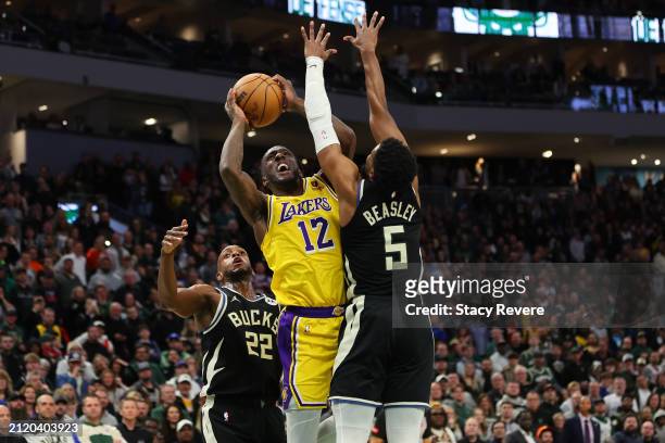 Taurean Prince of the Los Angeles Lakers is defended by Malik Beasley of the Milwaukee Bucks during a game at Fiserv Forum on March 26, 2024 in...