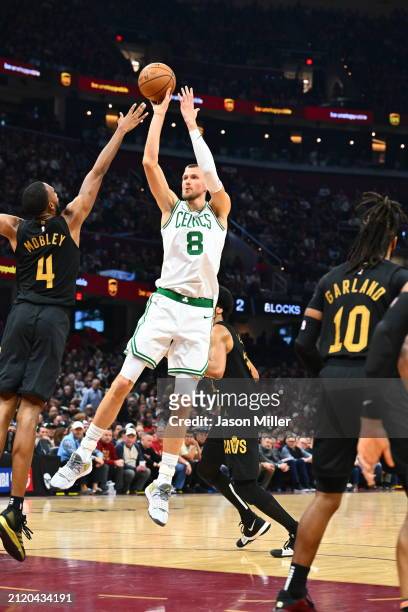 Kristaps Porzingis of the Boston Celtics shoots over Evan Mobley of the Cleveland Cavaliers during the first half at Rocket Mortgage Fieldhouse on...
