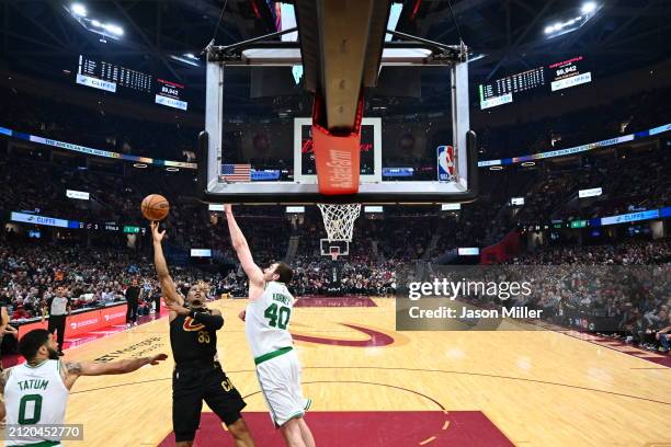 Isaac Okoro of the Cleveland Cavaliers shoots over Luke Kornet of the Boston Celtics during the first half at Rocket Mortgage Fieldhouse on March 05,...