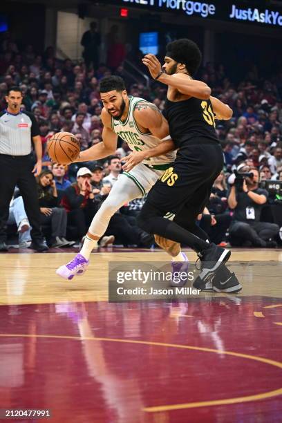 Jayson Tatum of the Boston Celtics drives to the basket around Jarrett Allen of the Cleveland Cavaliers during the first half at Rocket Mortgage...