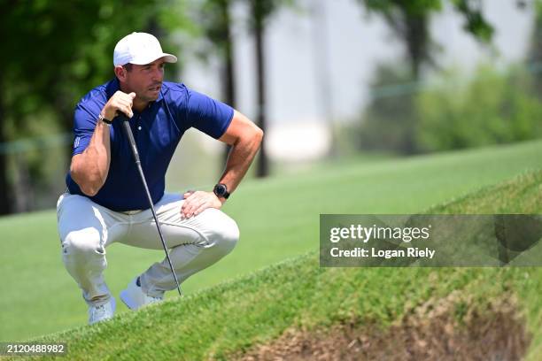 Scott Stallings of the United States lines up a shot on the 11th green during the first round of the Texas Children's Houston Open at Memorial Park...