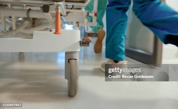 nurse, rush and stretcher in hallway of hospital with emergency, expert service and icu with legs on floor. healthcare, teamwork and doctor feet with bed for medical support and running with urgency - hospital bed legs stock pictures, royalty-free photos & images
