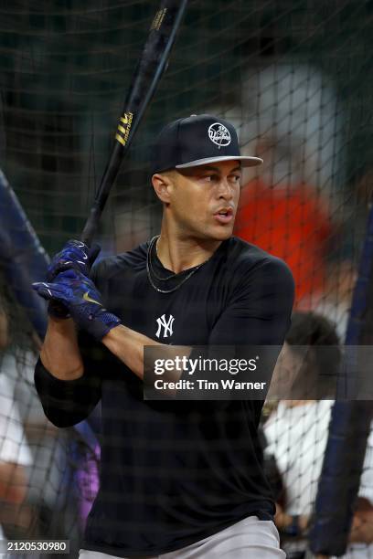 Giancarlo Stanton of the New York Yankees takes batting practice before the Opening Day game against the Houston Astros at Minute Maid Park on March...
