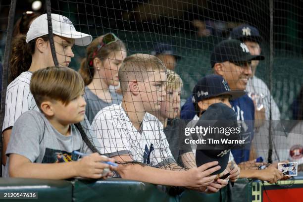New York Yankees fans watch players warm up before the Opening Day game against the Houston Astros at Minute Maid Park on March 28, 2024 in Houston,...