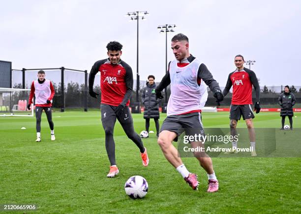Luis Diaz and Alexis Mac Allister of Liverpool during a training session at AXA Training Centre on March 28, 2024 in Kirkby, England.