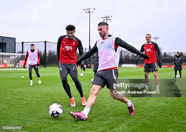 Luis Diaz and Alexis Mac Allister of Liverpool during a training session at AXA Training Centre on March 28, 2024 in Kirkby, England.