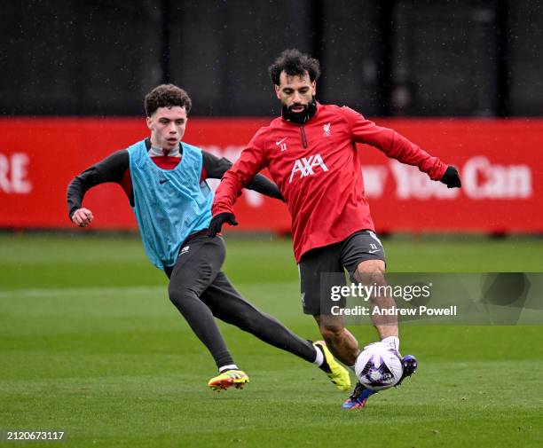 Mohamed Salah and Kieran Morrison of Liverpool during a training session at AXA Training Centre on March 28, 2024 in Kirkby, England.