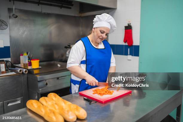 dedicated chef precisely preparing vegetables in nursing home kitchen - chopping vegetables stock pictures, royalty-free photos & images