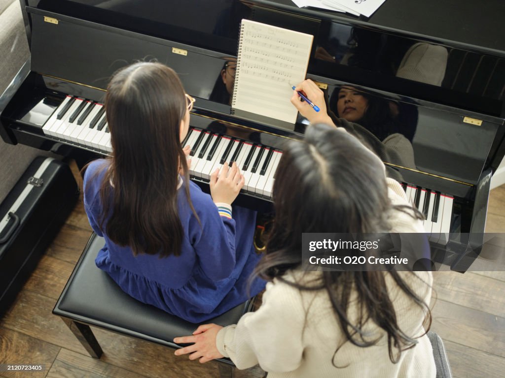 Piano Teacher and Student in a Home