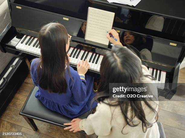 piano teacher and student in a home - piano bildbanksfoton och bilder