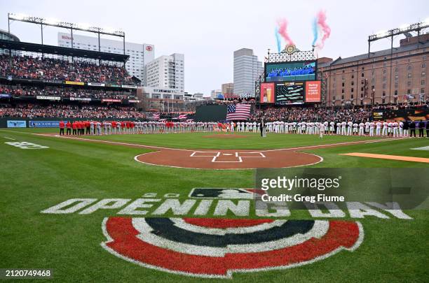 The Baltimore Orioles and Los Angeles Angels stand for the national anthem on Opening Day at Oriole Park at Camden Yards on March 28, 2024 in...