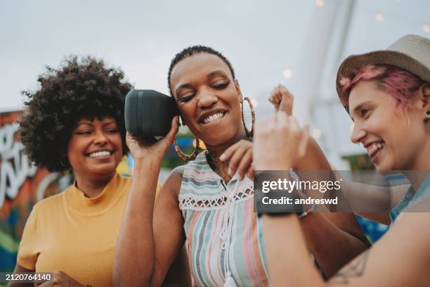 listening to music on the bluetooth speaker - bluetooth stock pictures, royalty-free photos & images