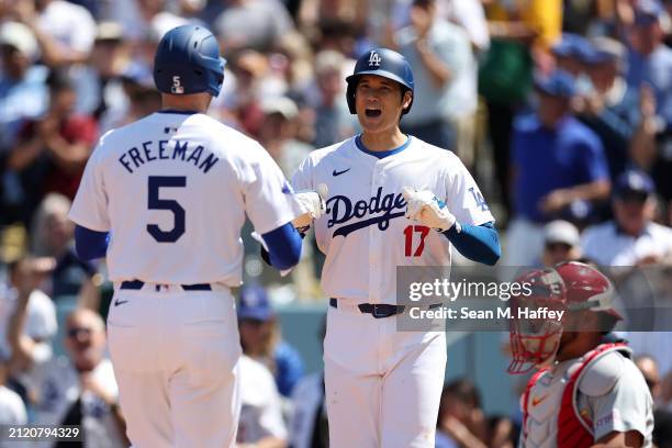 Shohei Ohtani congratulates Freddie Freeman of the Los Angeles Dodgers connects at the plate after his two-run homerun during the third inning of a...