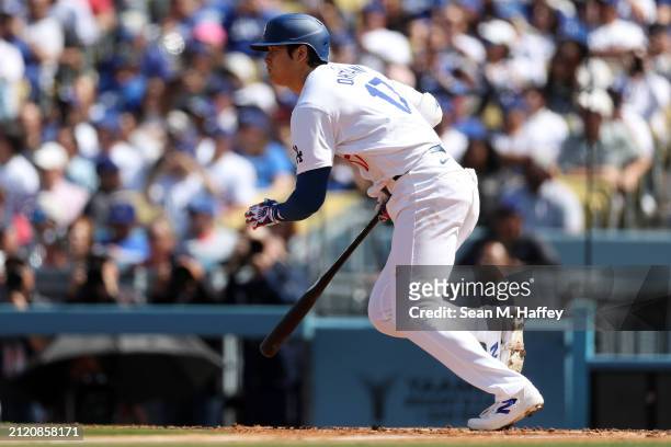 Shohei Ohtani of the Los Angeles Dodgers runs to first base after hitting a single during the fifth inning of a game against the St. Louis Cardinals...