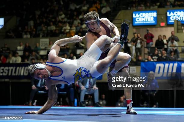 Bentley Schwanebeck-Ostermann of the Augsburg University Eagles wrestles Ryan DeVivo of the Johnson & Wales University Wildcats at 184 lbs. During...