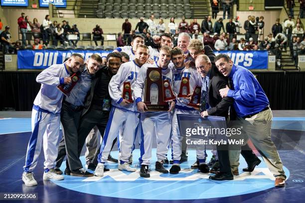 The Johnson & Wales University wrestling team poses with their trophy during the Division III Mens Wrestling Championship held at the La Crosse...