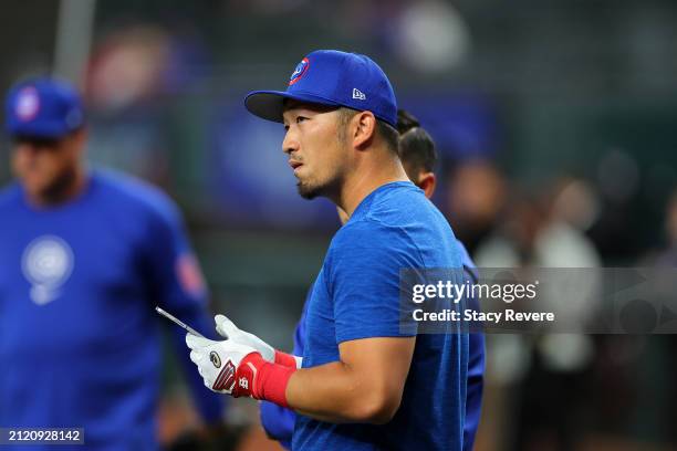 Seiya Suzuki of the Chicago Cubs participates in warmups prior to the Opening Day game against the Texas Rangers at Globe Life Field on March 28,...