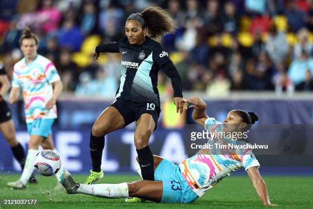 Elyse Bennett of San Diego Wave FC tackles the ball from Yazmeen Ryan of NJ/NY Gotham FC during the NWSL Challenge Cup at Red Bull Arena on March 15,...