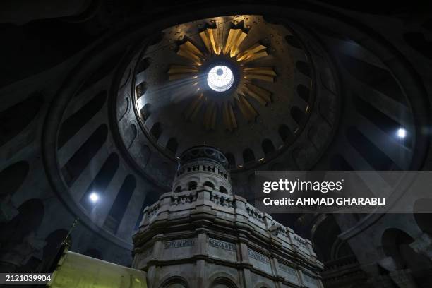 Light shines over the Edicule, traditionally believed to be the burial site of Jesus Christ, at the Church of the Holy Sepulchre in the Old City of...