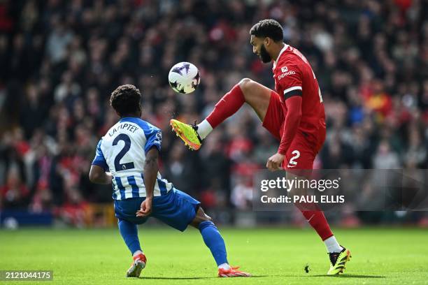 Liverpool's English defender Joe Gomez controls the ball past Brighton's English midfielder Tariq Lamptey during the English Premier League football...