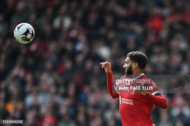 Liverpool's English defender Joe Gomez eyes the ball during the English Premier League football match between Liverpool and Brighton and Hove Albion...