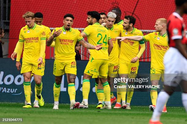 Nantes' French forward Matthis Abline celebrates scoring his team's first goal with teammates during the French L1 football match between OGC Nice...