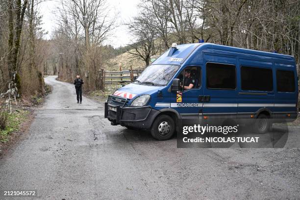 French Gendarme stands on the road to the French southern Alps tiny village of Le Haut-Vernet, in Le Vernet on March 31 after French investigators...