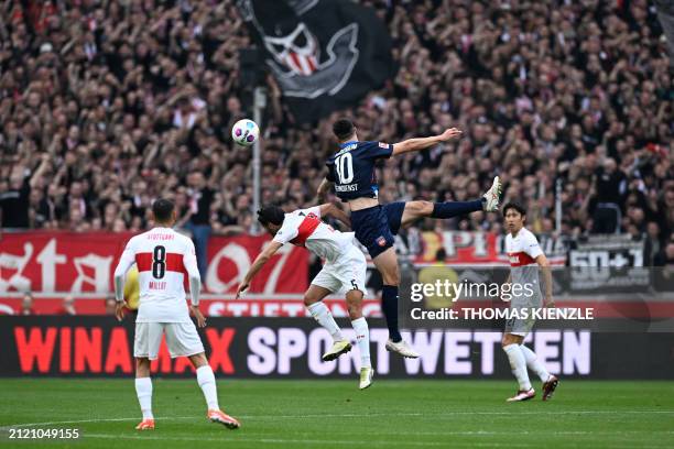 Stuttgart's German midfielder Mahmoud Dahoud and Heidenheim's German forward Tim Kleindienst vie for a headet during the German first division...