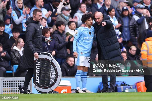 Rico Lewis of Manchester City comes on during the Premier League match between Manchester City and Arsenal FC at Etihad Stadium on March 31, 2024 in...