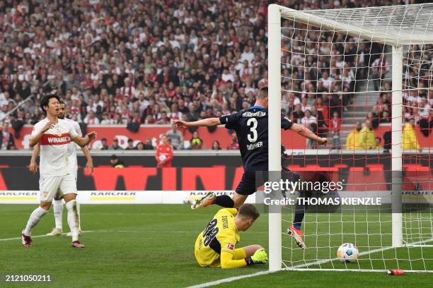 Heidenheim's German midfielder Jan Schoeppner reacts as Stuttgart's German goalkeeper Alexander Nuebel scores an own goal for Heidenheim during the...