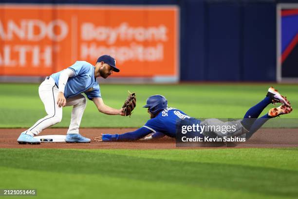 George Springer of the Toronto Blue Jays steals second base as Brandon Lowe of the Tampa Bay Rays attempts to tag during the first inning at...