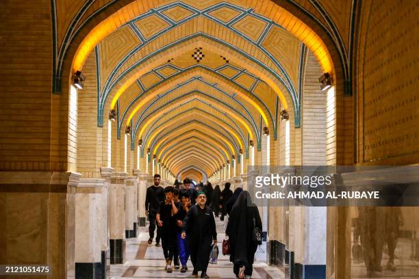 Shiite Muslim worshippers walk near the shrine of Imam Ali in the city of Najaf to commemorate the 7th century killing of Imam Ali, the first Shiite...