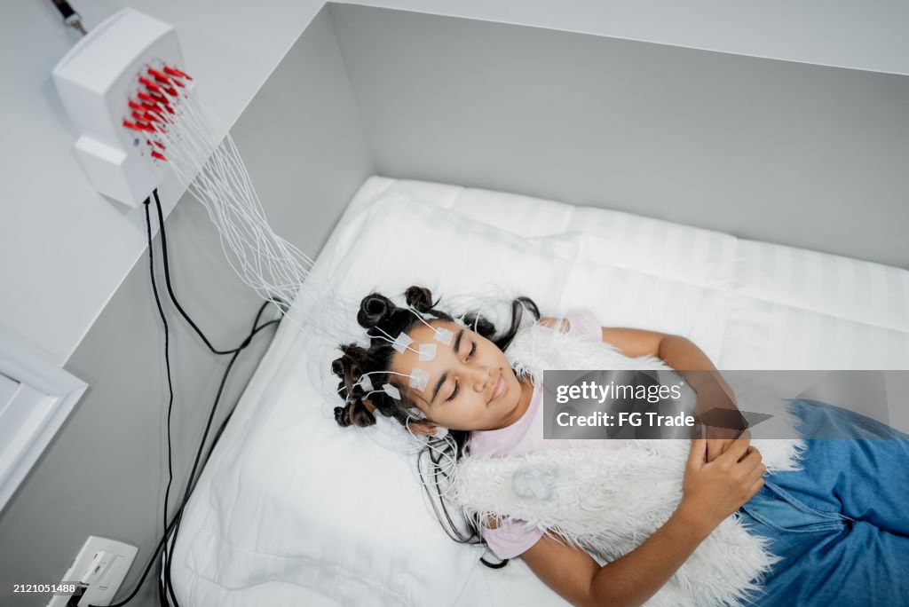 Child patient sleeping in a medical clinic doing polysomnography