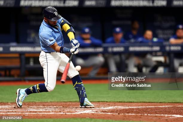 Jose Caballero of the Tampa Bay Rays hits a single during the third inning against the Toronto Blue Jays at Tropicana Field on March 31, 2024 in St...