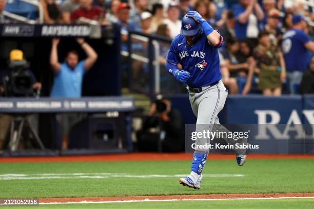 Justin Turner of the Toronto Blue Jays rounds third base after hitting a home run during the fifth inning against the Tampa Bay Rays at Tropicana...