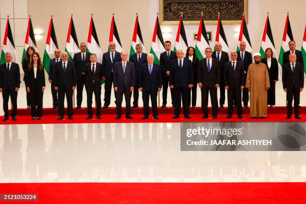 Palestinian Authority President Mahmud Abbas poses for a picture with new Palestinian government, after it was sworn in on March 31 in Ramallah, in...