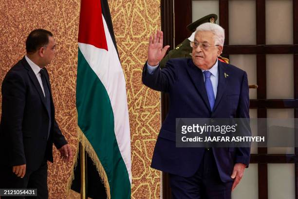 Palestinian Authority President Mahmud Abbas waves during a swearing in ceremony of mewly-appointed ministers, on March 31 in Ramallah, in the...
