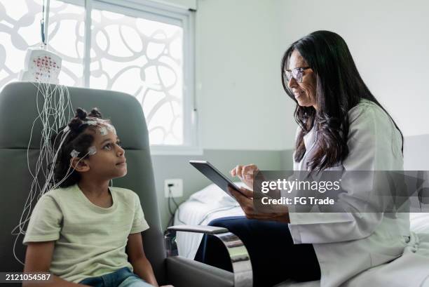 ärztin mit tablette und gespräch mit kind während der polysomnographie in der medizinischen klinik - eeg stock-fotos und bilder