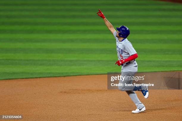 Chicago Cubs second baseman Christopher Morel points to the sky after hitting a home run during the game between the Texas Rangers and the Chicago...