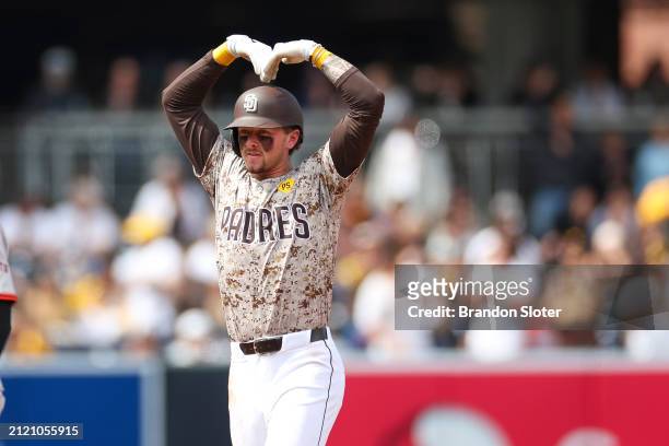 Jackson Merrill of the San Diego Padres celebrates after hitting an RBI double in the third inning during a game against the San Francisco Giants at...