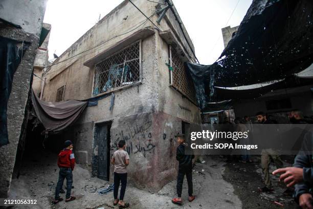 Palestinians inspect the house where three young Palestinians were killed by Israeli forces during a raid on the Damj neighborhood in Jenin camp,...