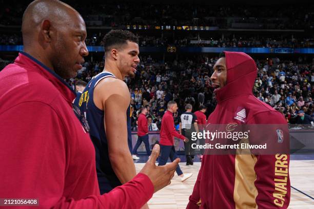 Donovan Mitchell of the Cleveland Cavaliers talks to Michael Porter Jr. #1 and Assistant Coach Popeye Jones of the Denver Nuggets after the game on...