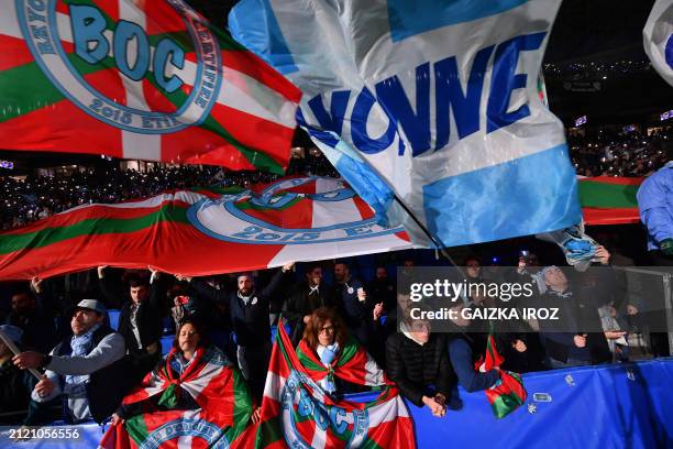 Bayonne's supporters wave flags as they cheer at their team prior to the French Top 14 rugby union match between Aviron Bayonnais and Rugby Club...