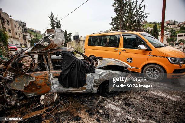 View of a charred Palestinian car that was bombed by an Israeli plane, resulting in the injury of three Palestinians who were subsequently arrested...