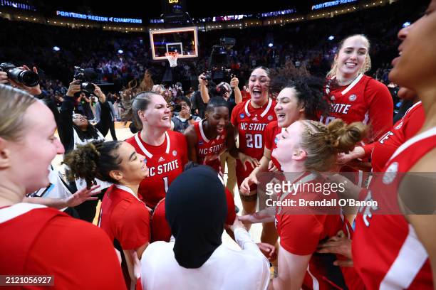 The NC State Wolfpack celebrate their 76-66 win over the Texas Longhorns during the Elite Eight round of the 2024 NCAA Women's Basketball Tournament...