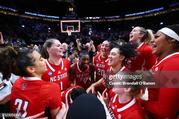 The NC State Wolfpack celebrate their 76-66 win over the Texas Longhorns during the Elite Eight round of the 2024 NCAA Women's Basketball Tournament...